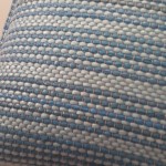 Gray pillow with blue stripes